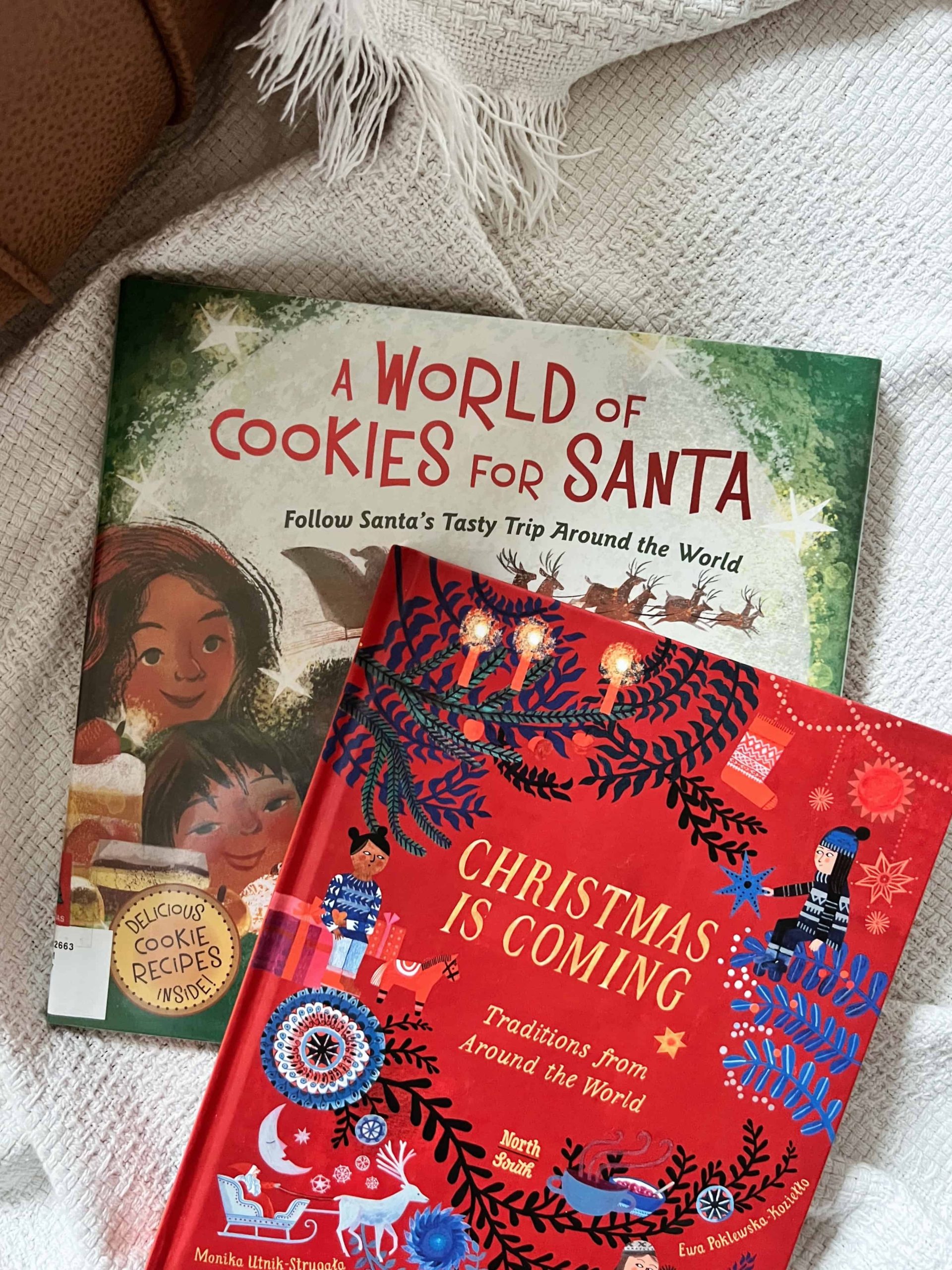 Explore Christmas traditions from around the world with the Global Explorers Club's Christmas Around the World Book List this holiday season. Books pictured in this image include Christmas is Coming: Traditions from Around the World by Monica Utnik and A World of Cookies for Santa: Follow Santa's Tasty Trip Around the World by M.E. Furman.