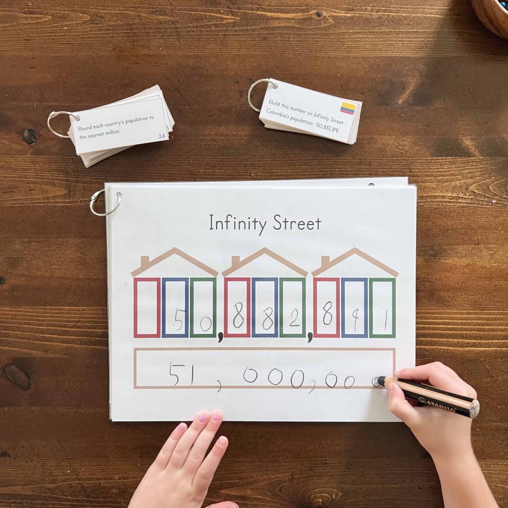 A child learns how to round country populations to different place value positions using the Global Explorers Club's Infinity Street activity pack. 