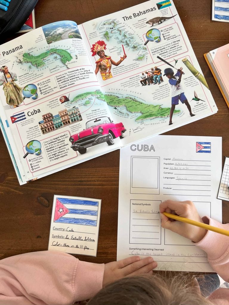 A child fills out the Global Explorer's journal page for Cuba, part of the North America unit study included in its geography homeschool curriculum